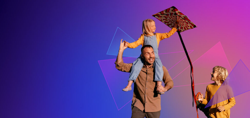 a man carrying a child on his shoulders